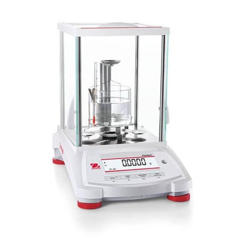 Analytical balance with a density kit and beaker inside its glass draft shield