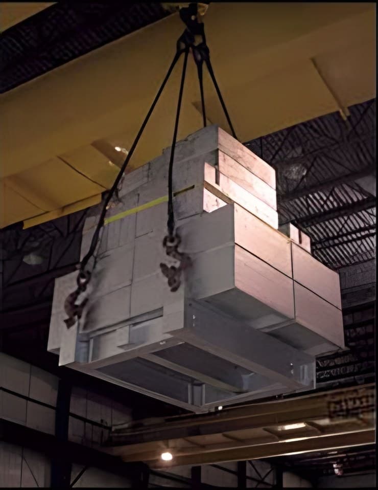 Stack of certified test weights hung from an overhead crane for a load test