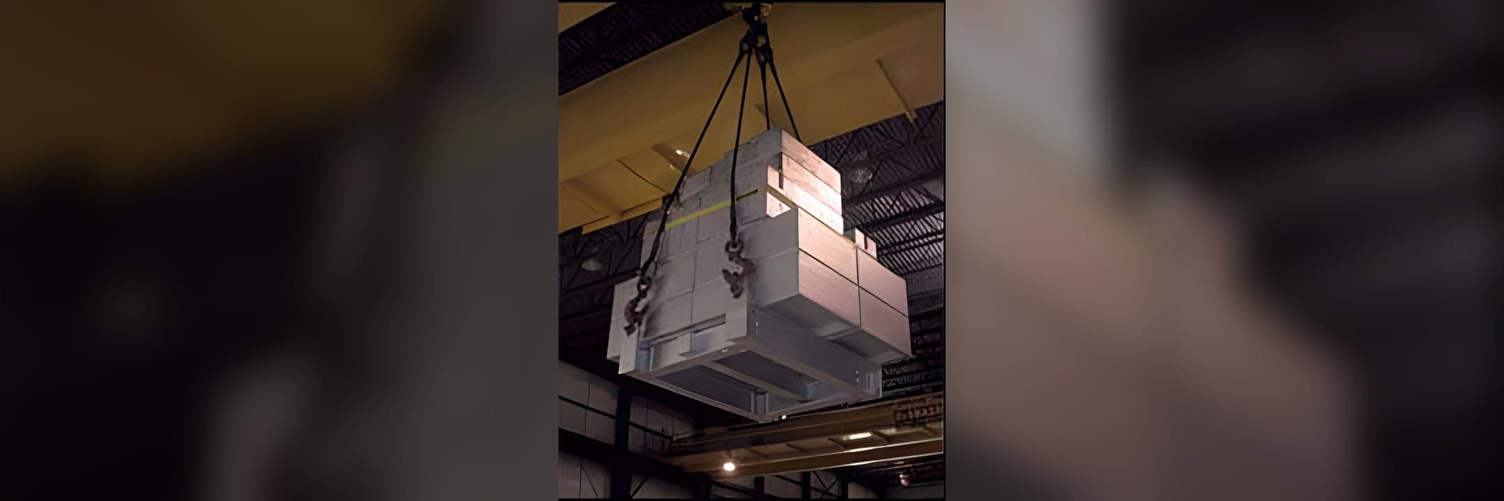 Certified test weights hung from an overhead crane for a load test