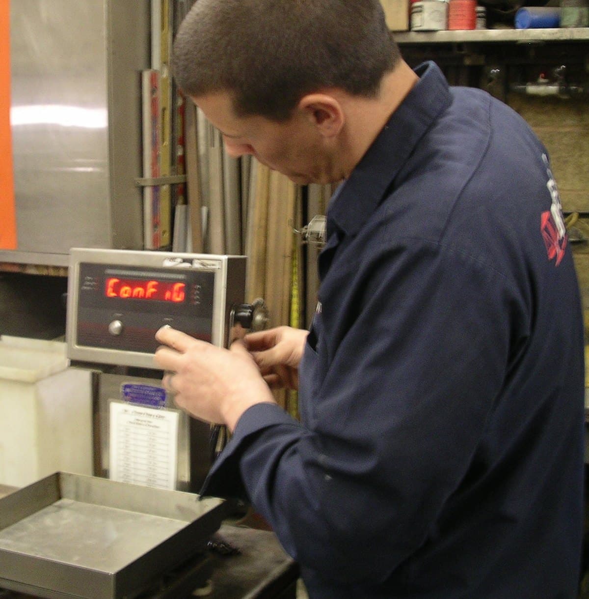 Bitterman technician configuring the indicator while calibrating a bench scale